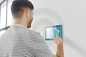 Man looking at tablet computer at smart home