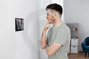 Man looking at tablet computer at smart home