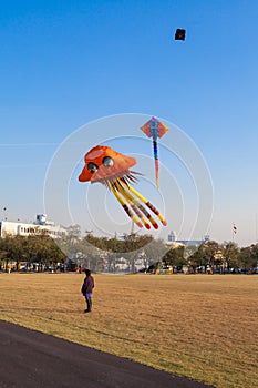 Man looking to colorful flying kite on sunny day