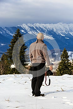 Man looking to a mountain winter landscape