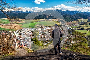 Man looking from top of the hill at city