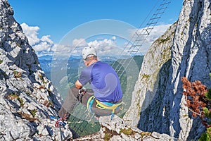 Man looking towards the via ferrata ladder at Intersport Klettersteig, near Gosau, Austria photo