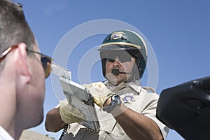 Man Looking At Traffic Cop Holding Clipboard