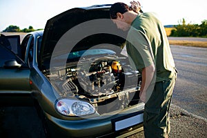 Man Looking Under The Hood Of Breakdown Car van.