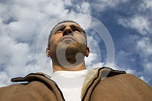 Man Looking up with the Clouds on the Background photo
