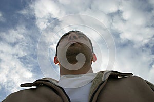 Man Looking up with the Clouds on the Background