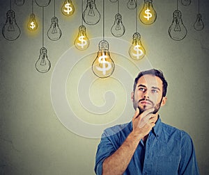 Man looking up with dollar idea light bulb above head