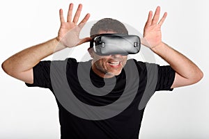 Man looking in VR glasses and gesturing with his hands.