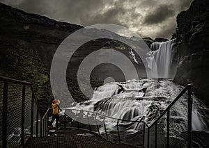 Man looking at a waterfall