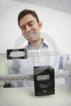 Man Looking At Weight Scale