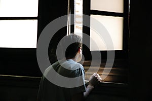 Man looking through window