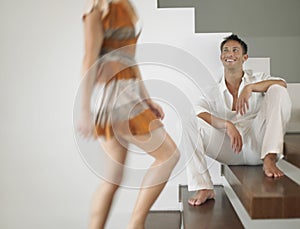 Man Looking At Woman On Stairs