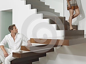 Man Looking At Woman On Stairs