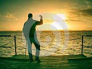 Man lookking over silent sea to horizon