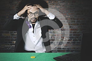 Man looks frustrated after lose in online poker