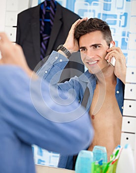 Man looks himself at mirror while preparing for job