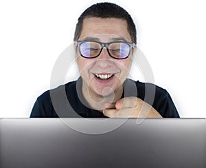 The man looks into the laptop, laughs and is surprised at what he saw there. Expression of emotions and reaction to what you see