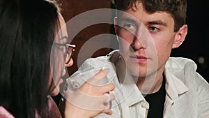 Man looks in love at woman drinking alcoholic cocktail