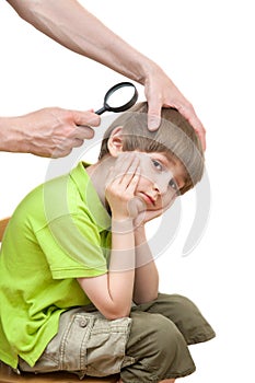 Man looks nits at the boy's head