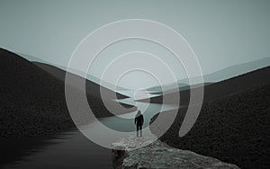 A man looks over the top of the mountain a lake and forest