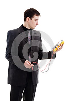 Man looks at the testimony of a multimeter.