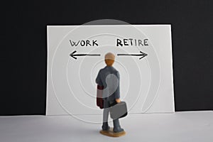 Man looks to work and retire inscription with arrows. Retirement concept