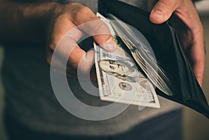 Man looks in the wallet. Cash. Wealthy man counting his money. Close up.