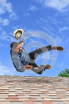 Man Loosing Balance on Top of Roof