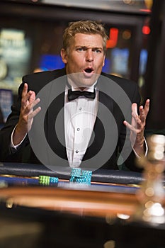 Man losing at roulette table