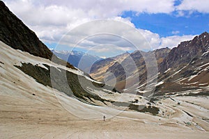 A man lost in the vastness of the snow clad mountain