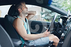 Man with back pain after a long drive in car