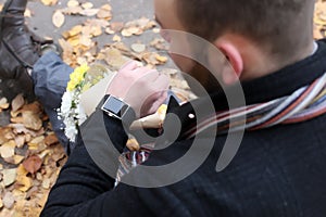 Man in love waiting date in autumn park