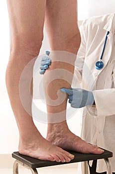 Man Lower limb vascular examination by phlebologist photo