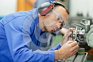 man lubricates machine