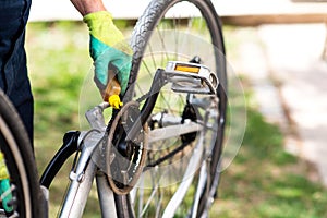 Man lubricating bicycle chain maintaining for the new season photo