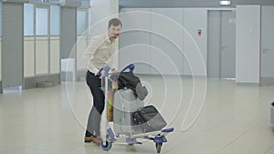 The man with luggage in the airport building