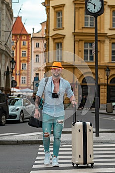 Man with luggage for vacation, trip. Man tourist with travel bag. Traveler tourist man in casual clothes with suitcase