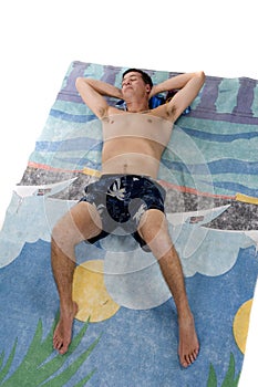 Man lying on beach towel