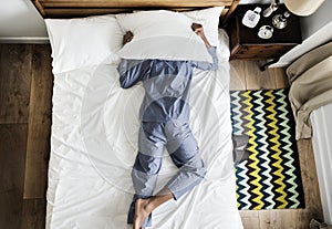 Man lying on bed with insomnia