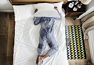 Man lying on bed with insomnia photo