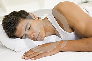 Man lying in bed sleeping photo