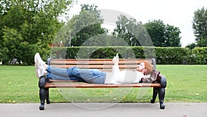 Man Lying on Bench in Park and Using Smartphone, Red Hairs