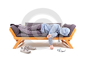 Man lying on couch with hangover. photo
