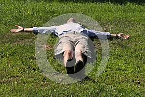 Man lying down like a cross photo