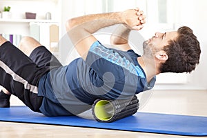 Man Lying on a Foam Roller While Doing an Exercise