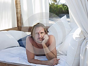 Man Lying In Four-Poster Bed