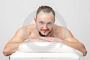 Man lying on front on table spa