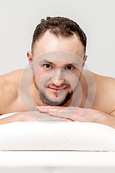 Man lying on front on table spa