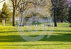 A man lying on green meadow in a sunny day and relaxing. Copy space