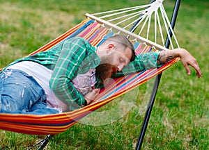 The man is lying on a hammock.